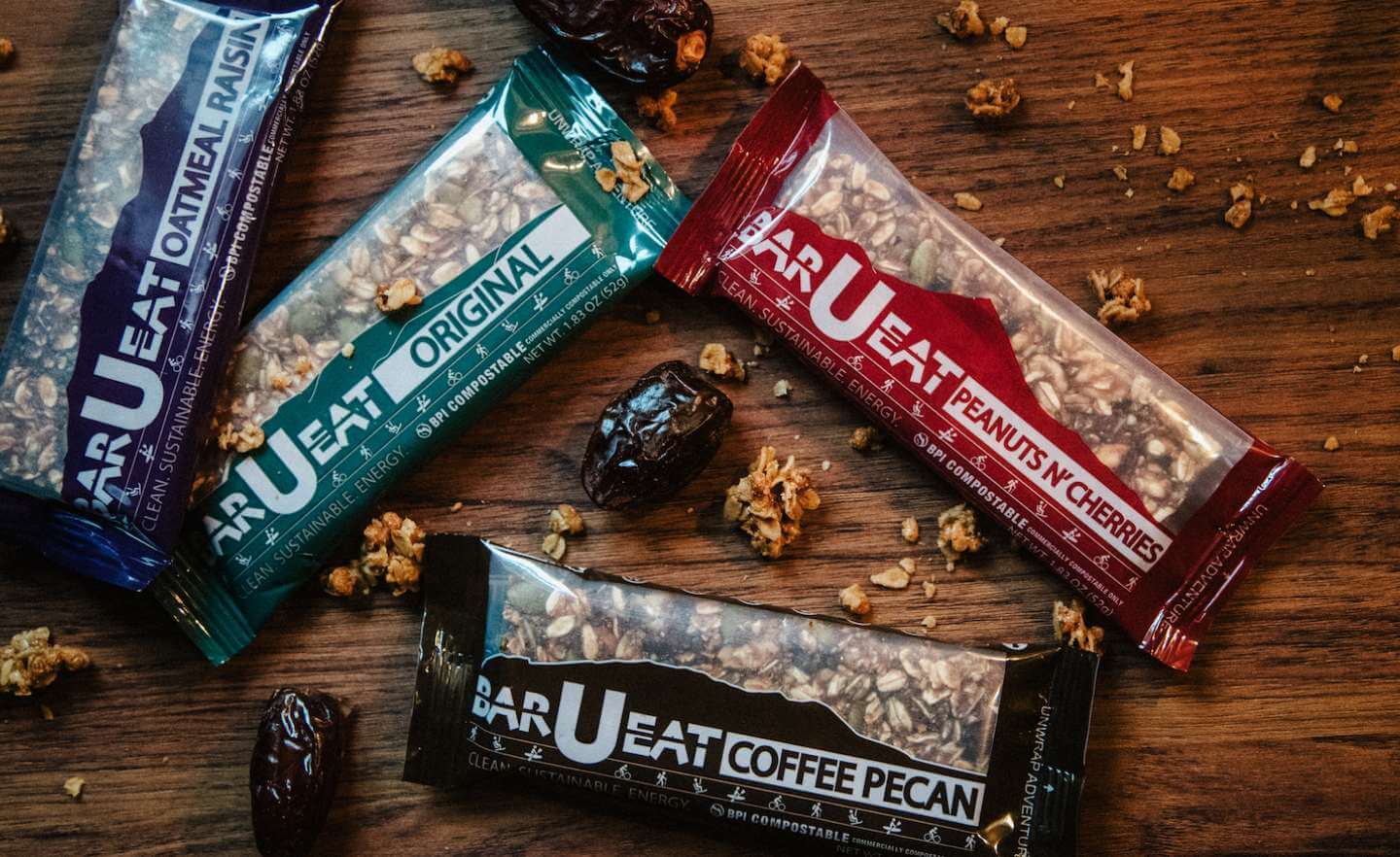 Photograph of bars on a table surrounded by dried cherries and granola.