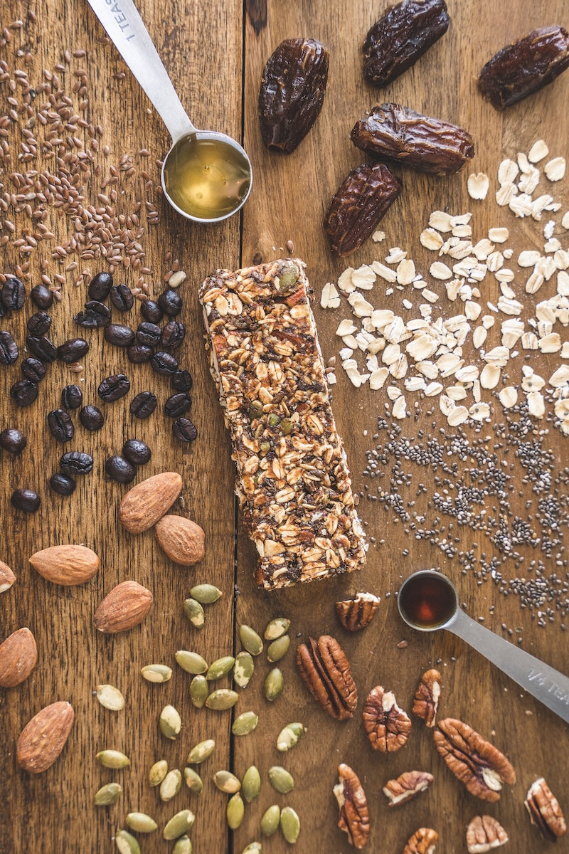 bar u eat energy bar with oats nuts and seeds spread around it