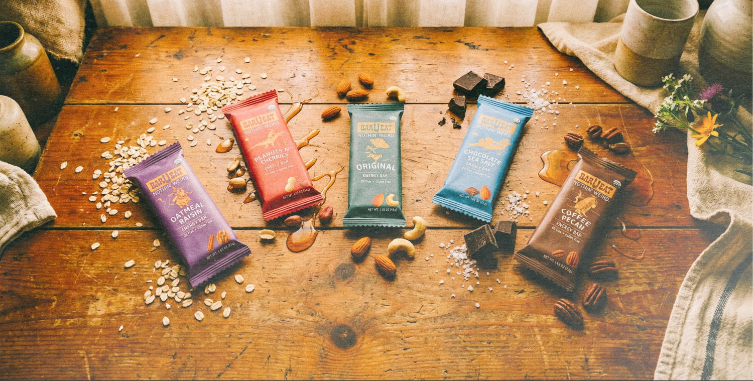 Various barueat energy bars on a wooden table with a soft, natural light background