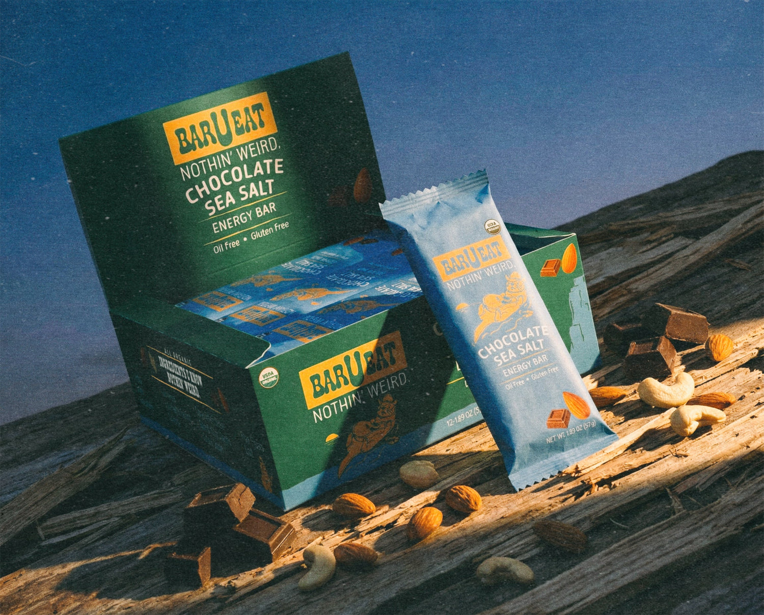 Box of Barqeat chocolate sea salt energy bars on a wooden surface with a blue background