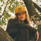 woman wearing the date palm hat in a tree