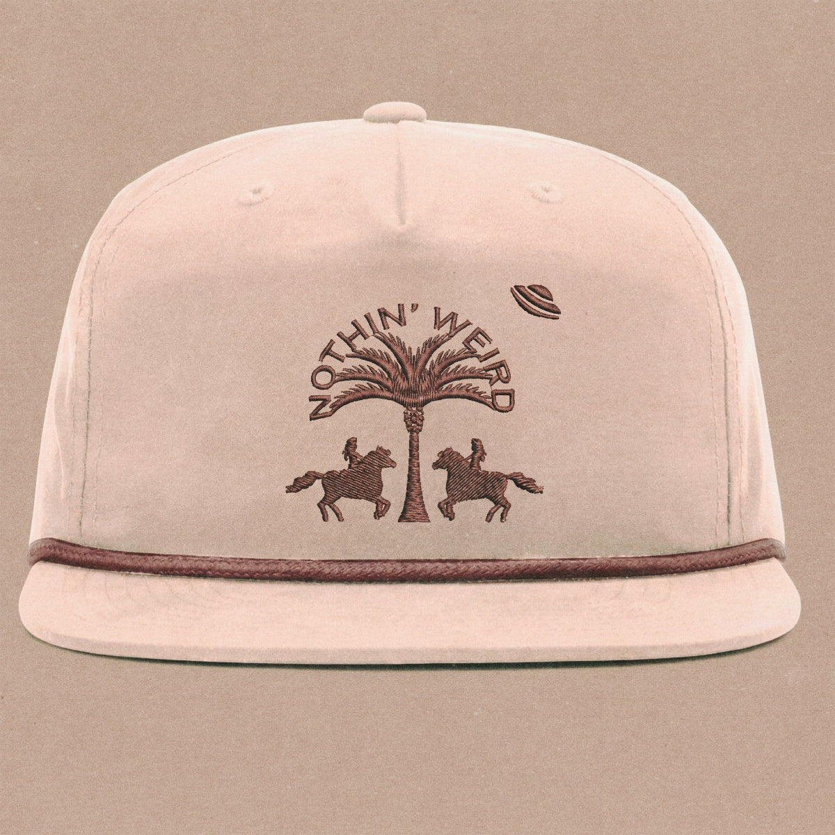 Mauve ball cap with western horses, palm tree, and ufo stitched on it.