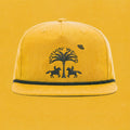 Mustard yellow ball cap with western horses, palm tree, and ufo stitched in black on it.