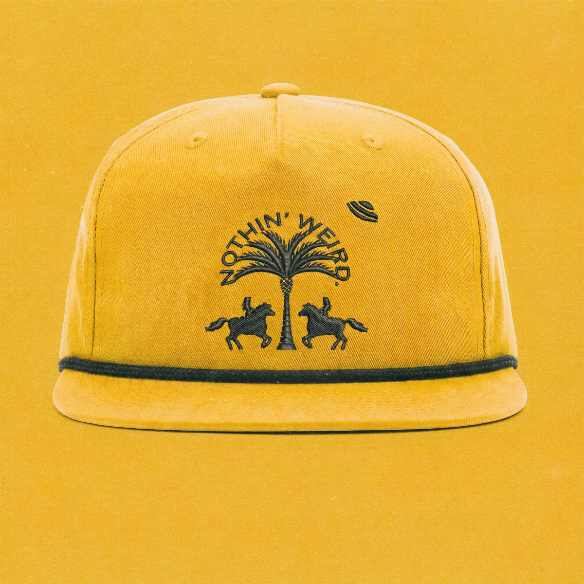 Mustard yellow ball cap with western horses, palm tree, and ufo stitched in black on it.
