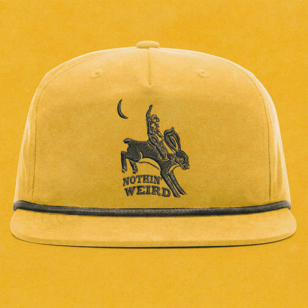 Mustard yellow and black hat with a cowboy riding a bunny rabbit. Funny western hat.