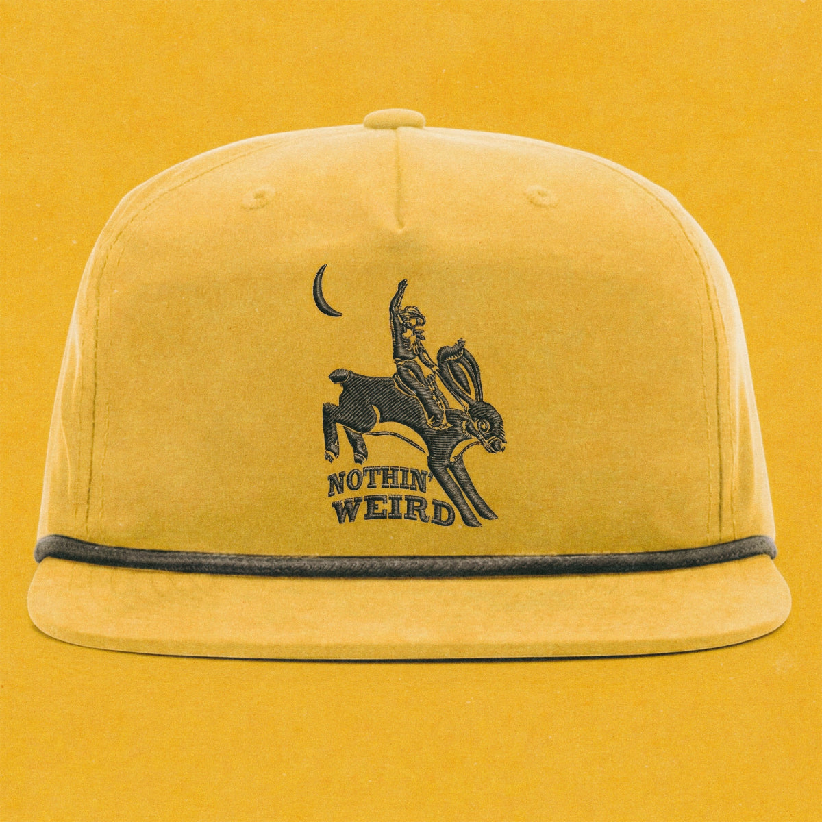 Mustard yellow and black hat with a cowboy riding a bunny rabbit. Funny western hat.