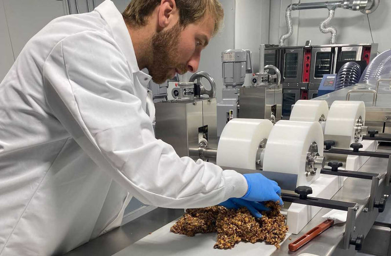 person making bars in the bar you eat factory