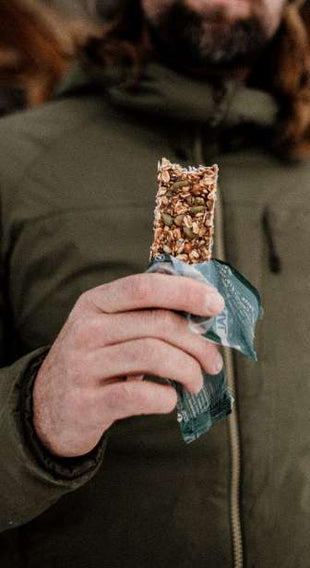 person eating a granola bar