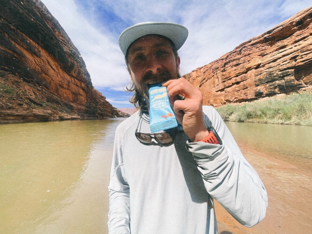 Eating a bar on a river through canyon country